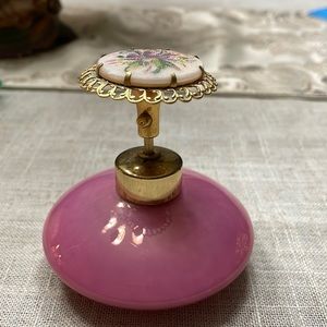 This is a pink antique design perfume bottle
